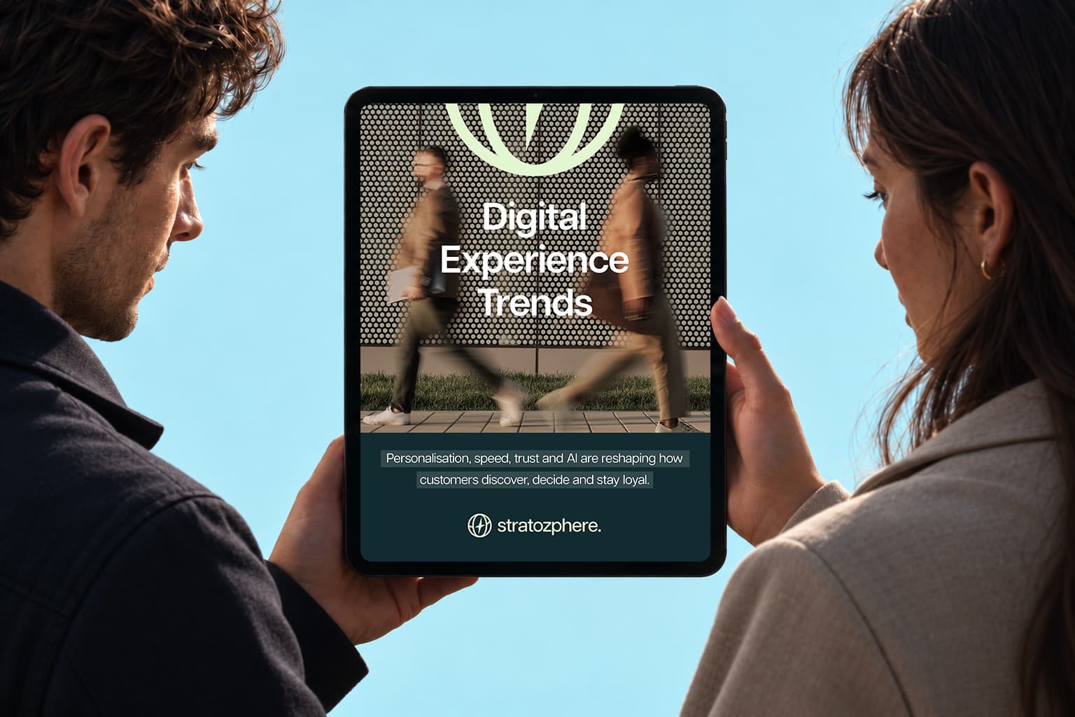 Two people reviewing a digital experience guide on a tablet