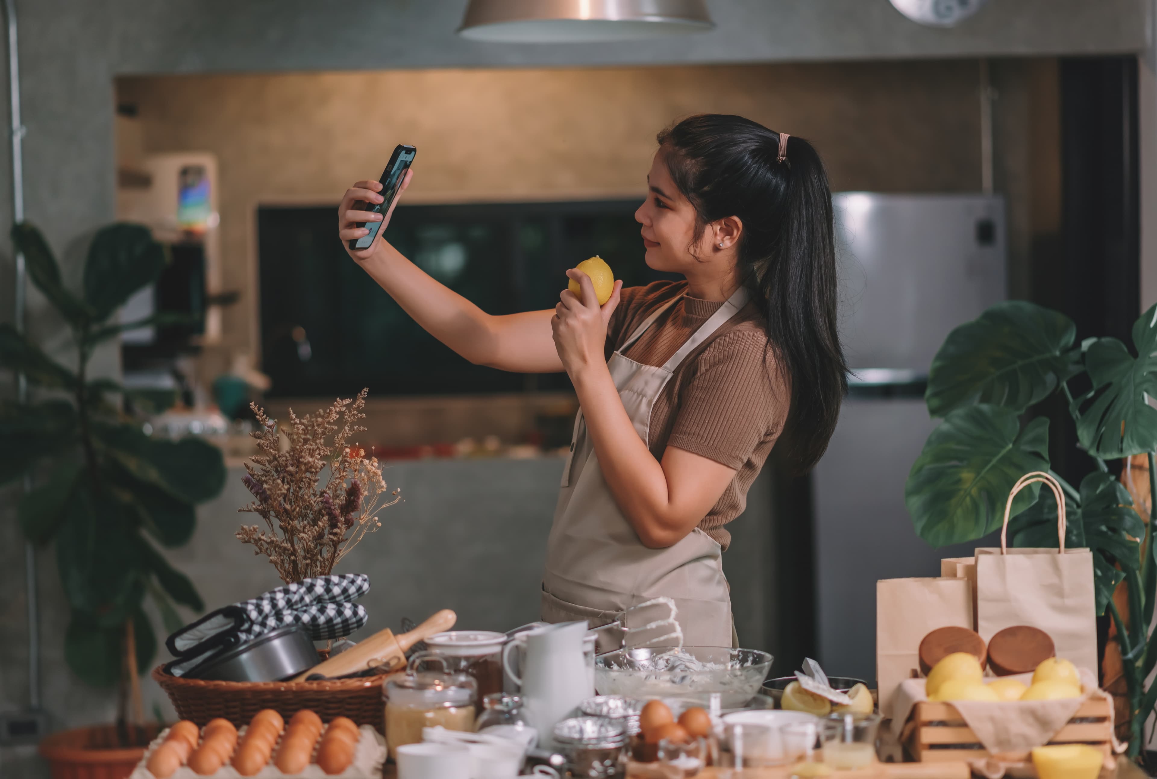 A business owner photographing work in a kitchen